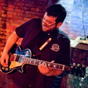 Anthony Sloan the music instructor playing guitar