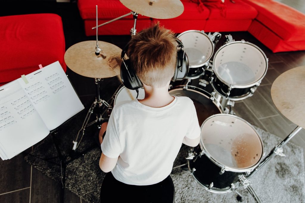 little kid practicing drums