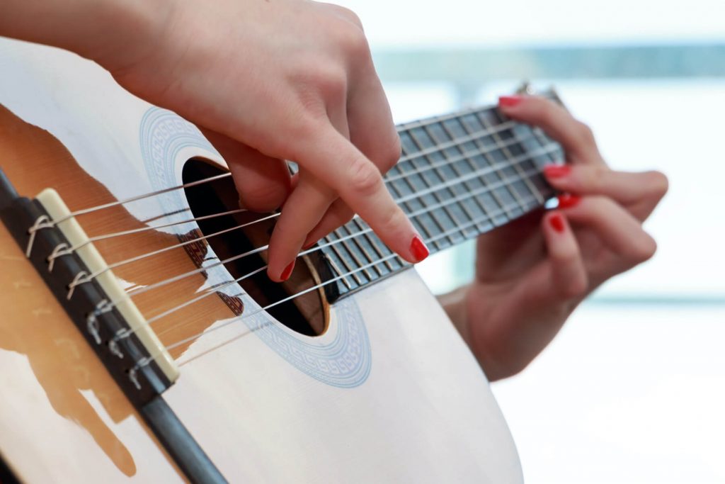 someone playing guitar closeup