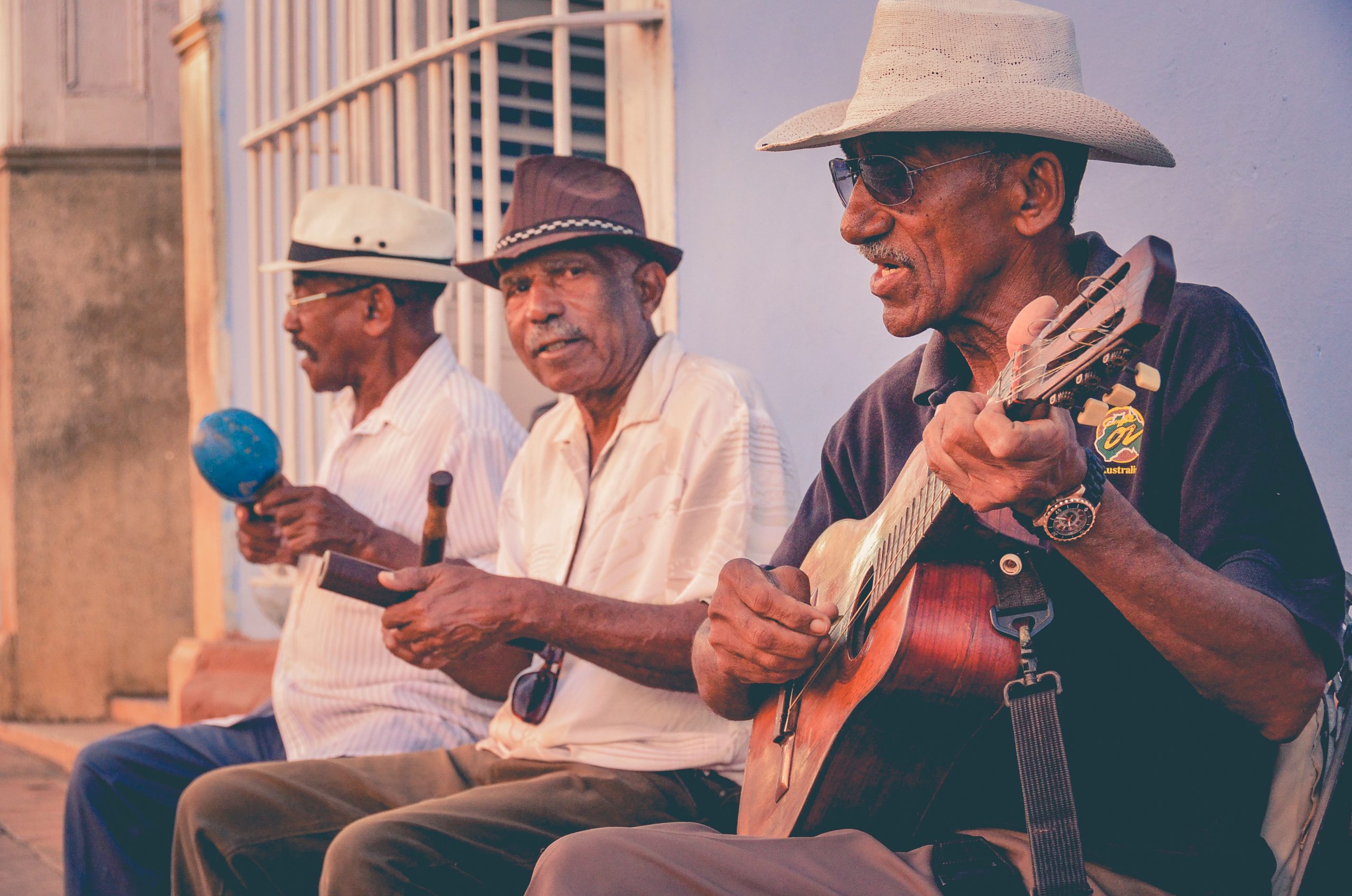 three adults learning music outside