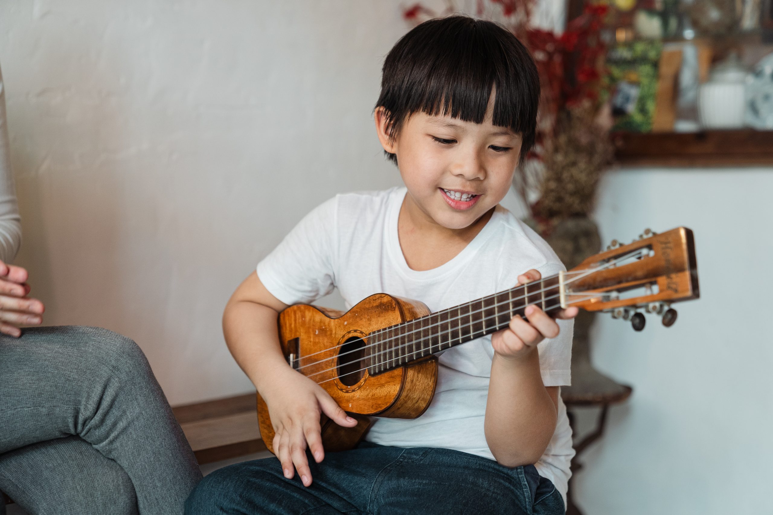 boy performing music ukulele