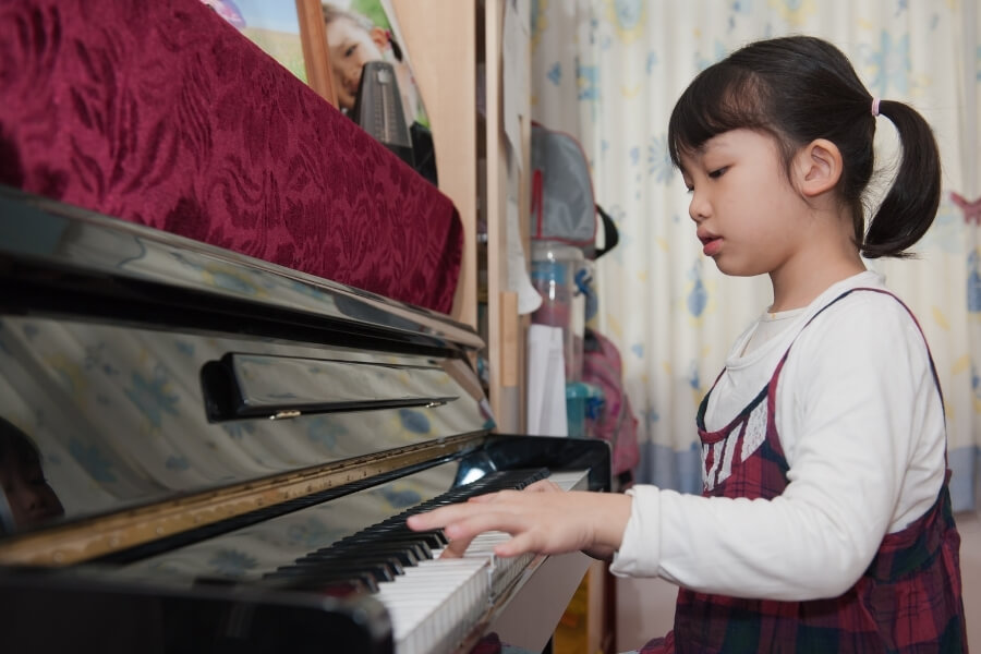 A little girl playing piano